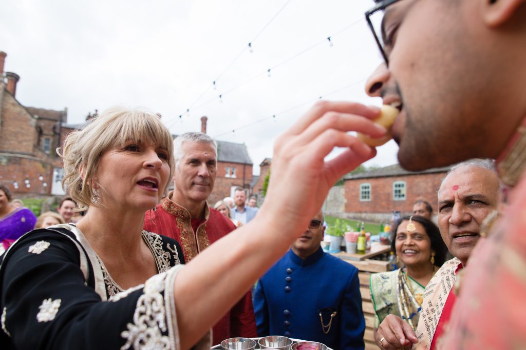 mother of bride feeding groom