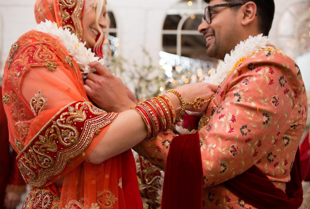 couple exchanging flower garlands