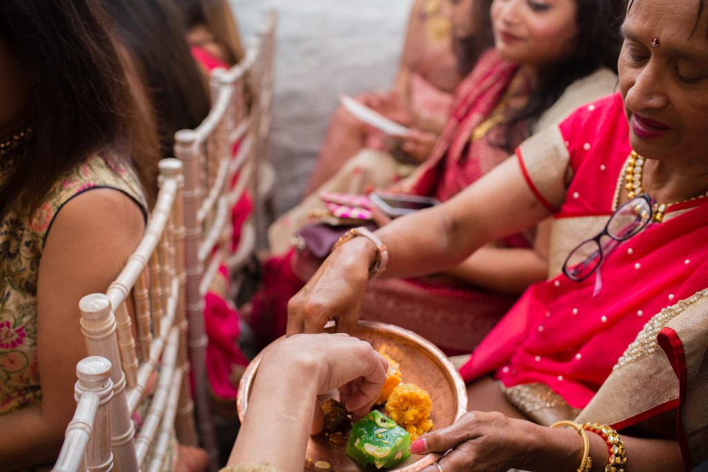 sweets being passed round during hindu wedding