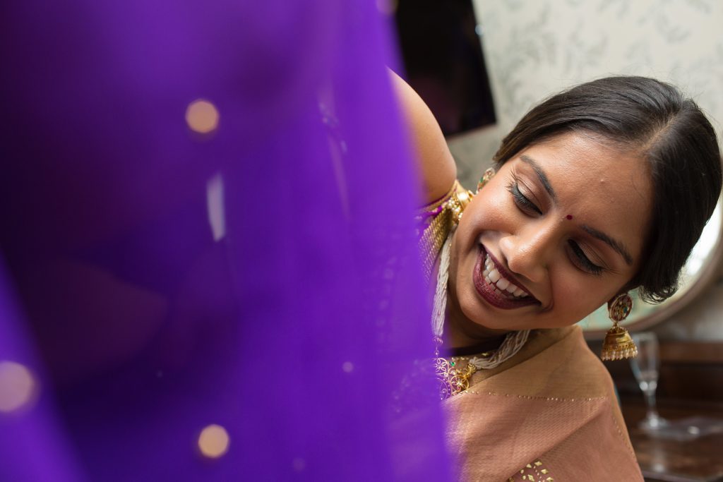bride having help getting ready