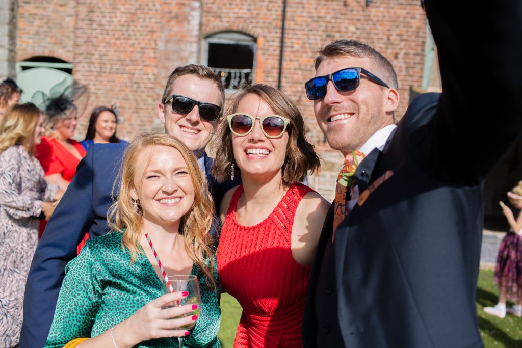 best man taking selfie with wedding guests