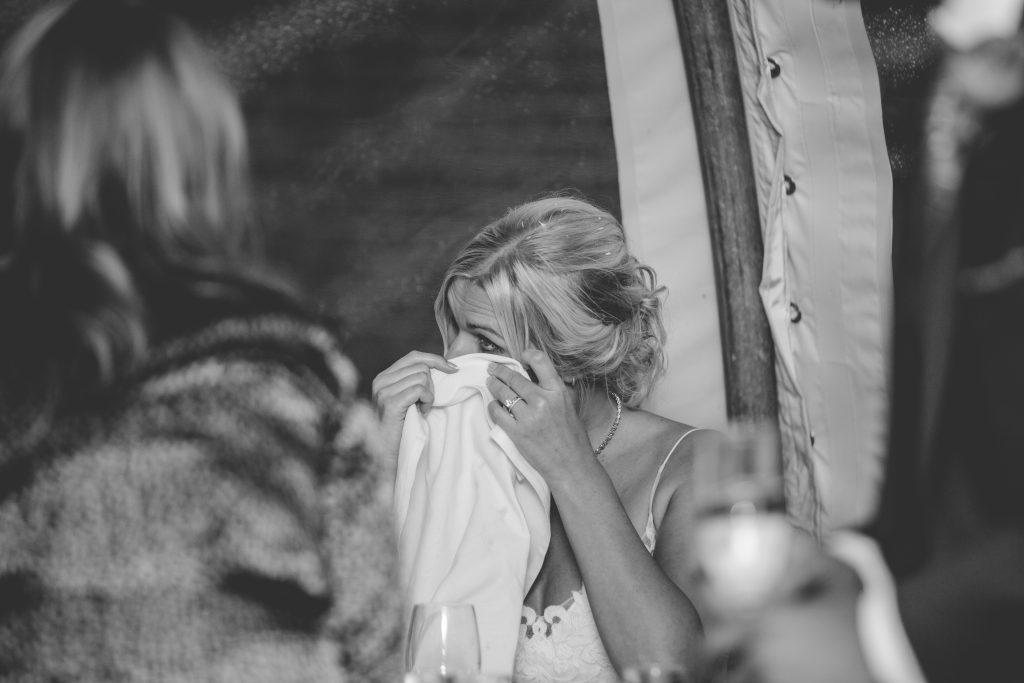 bride wipping tear from eye